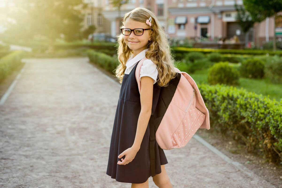 Young student wearing backpack smiling